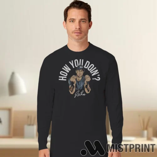 Male Model Wearing Joey Gallo How You Doin New York Yankees Signature Funny Baseball Men's Black Long Sleeve in a minimalist gray office background. Styled with a casual long sleeve top.