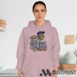 Female Model Wearing 90s Cartoon Mickey Mantle New York Yankees Women's Light Pink Hoodie in a white office environment. Features a cozy pullover hoodie.