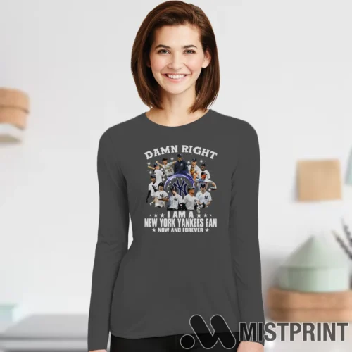 Female Model Wearing Damn Right I'm A New York Yankees Fan Women's Charcoal Long Sleeve in a minimalist white office background. Styled with a casual long sleeve top.
