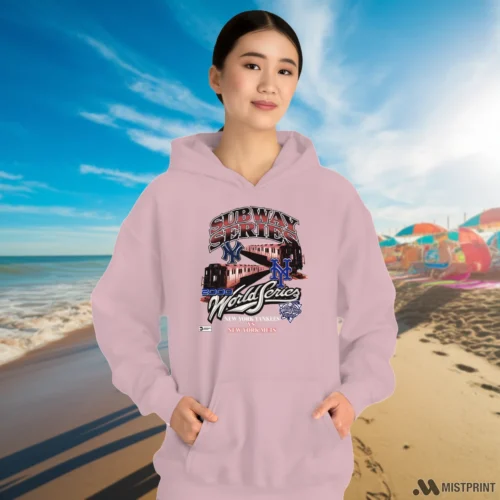 New York Mets Vs New York Yankees Subway Series Women’s Light Pink Hoodie – Female Model in White Office Female Model Wearing New York Mets Vs New York Yankees Subway Series Women's Light Pink Hoodie in a white office environment. Features a cozy pullover hoodie.