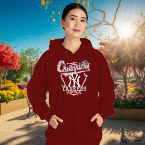 New York Yankees 1998 World Series Champions Women’s Maroon Hoodie – Female Model in Gray Office Female Model Wearing New York Yankees 1998 World Series Champions Women's Maroon Hoodie in a gray office environment. Features a cozy pullover hoodie.